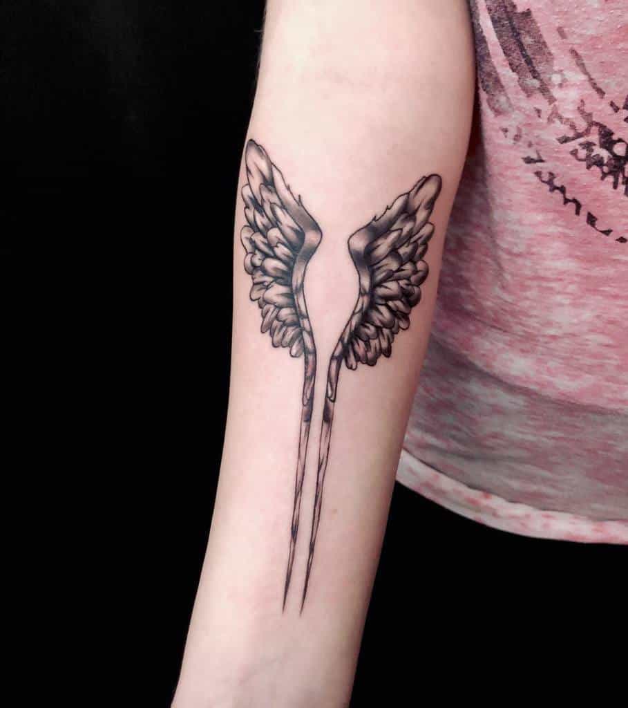 creative small wing tattoo on forearm placements.