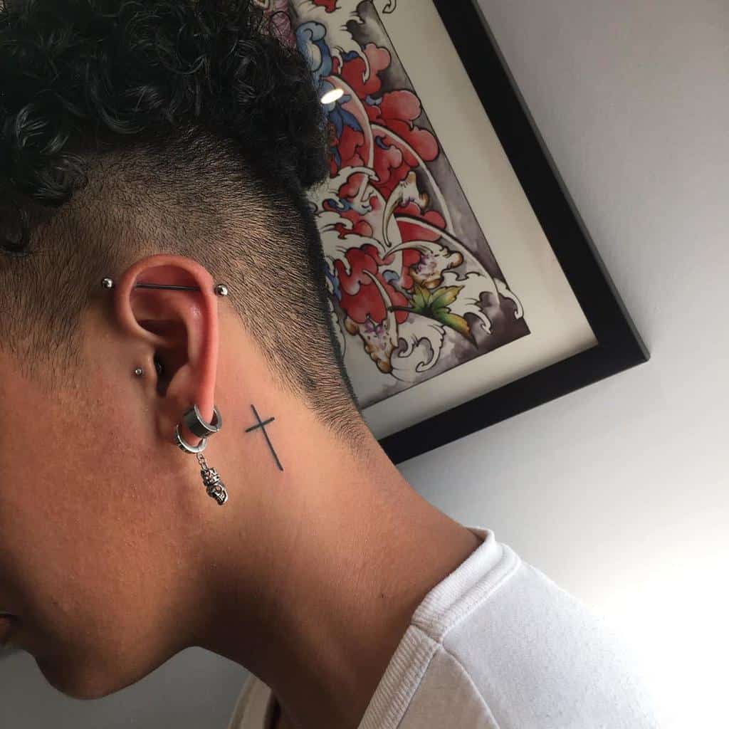 cute small cross face tattoo options.