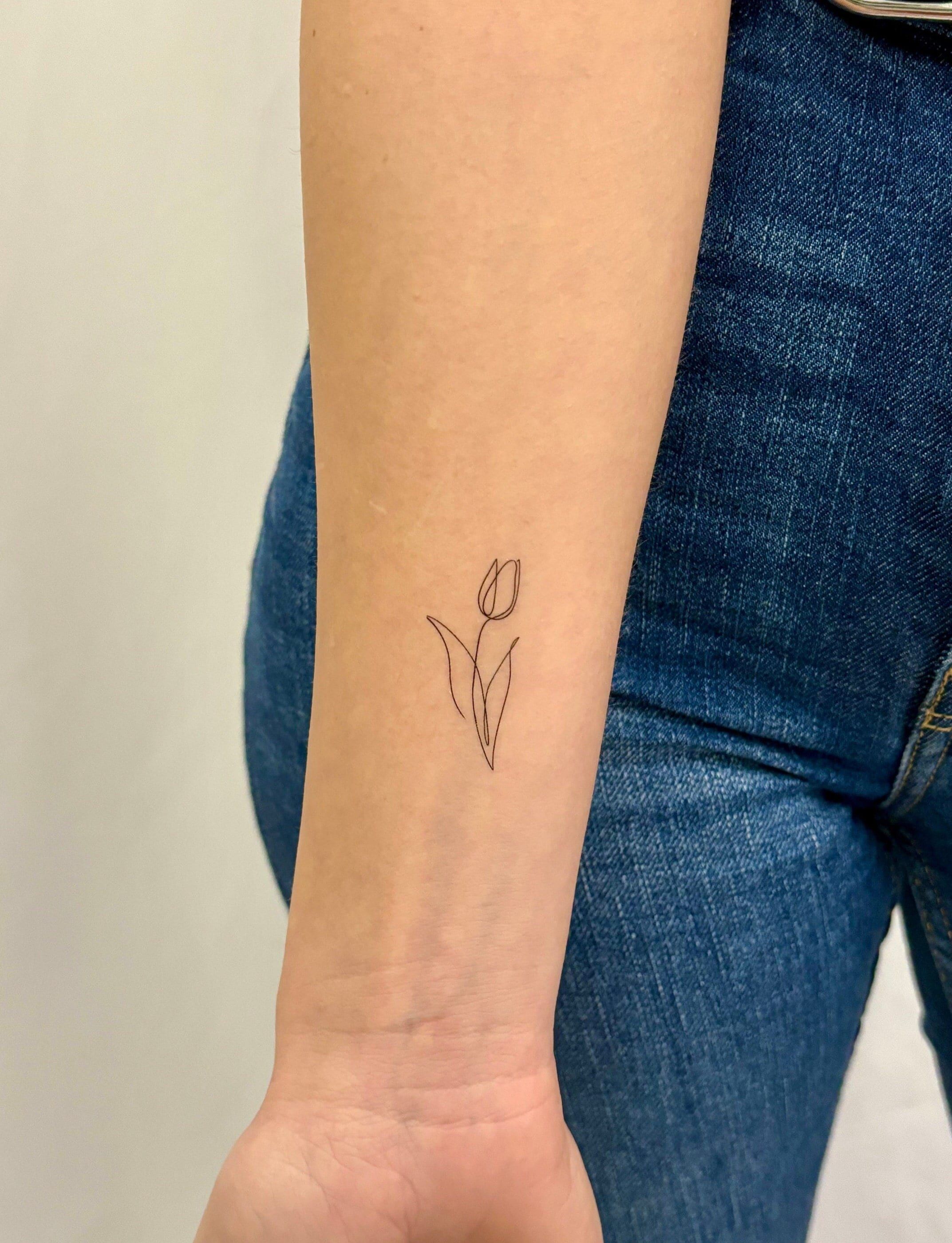 Cute small tulip tattoo designs.