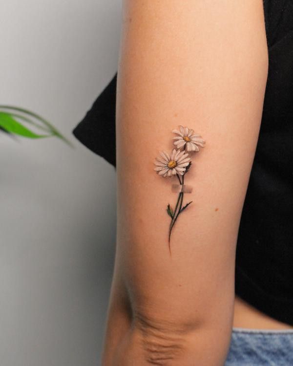 daisy flowers as tattoo symbols