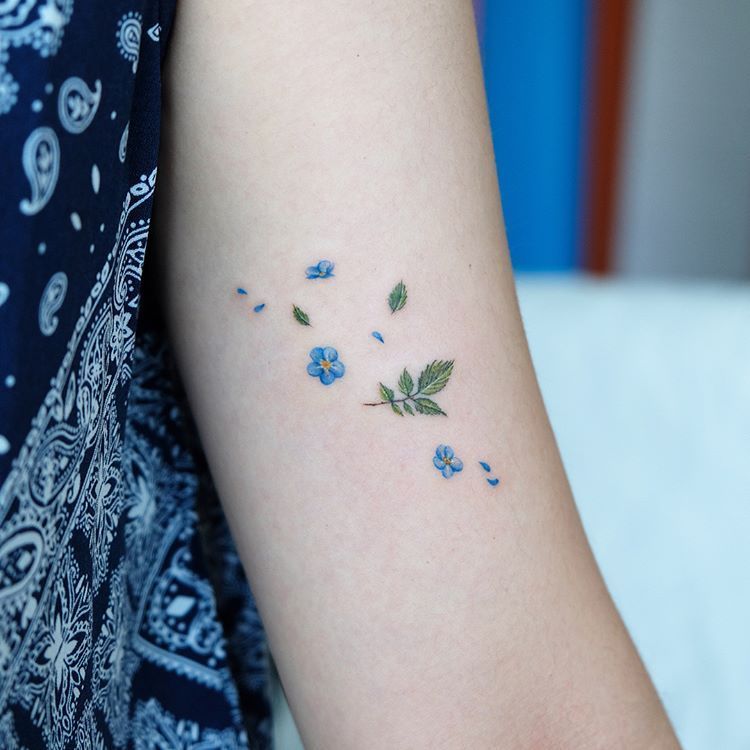 delicate small elephant tattoos with floral elements