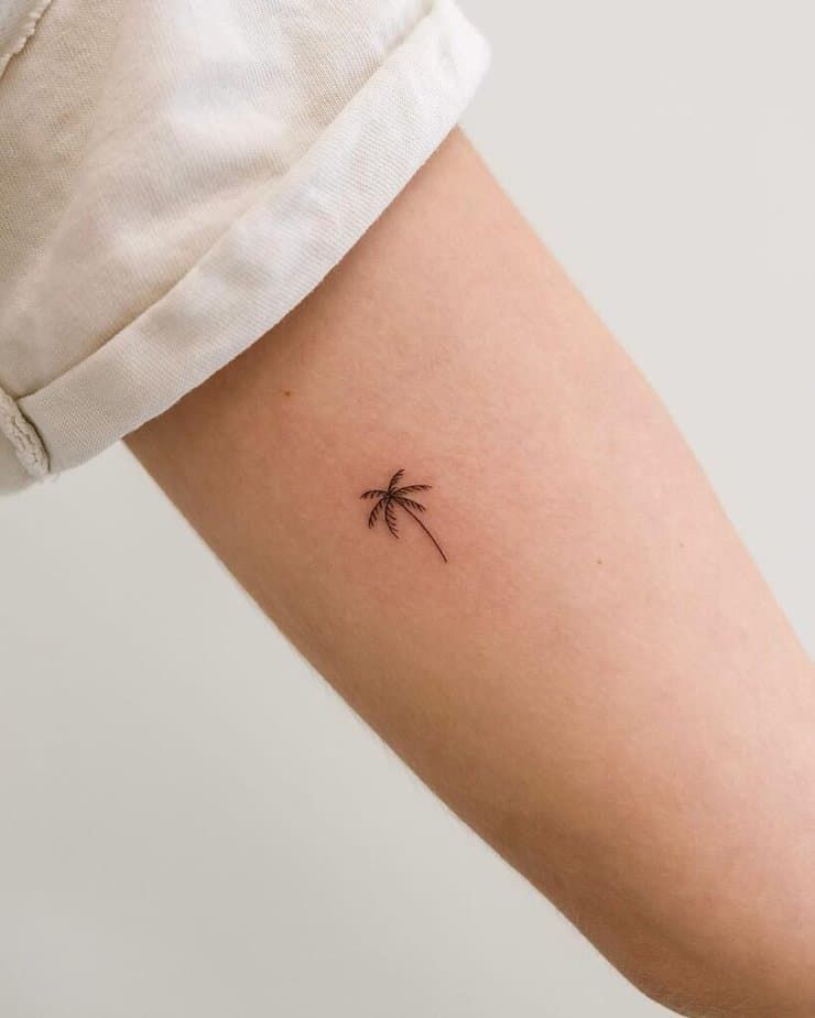 delicate small palm tree tattoo art