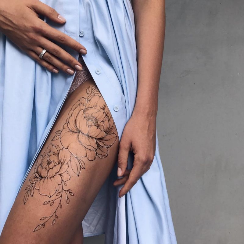 delicate upper thigh tattoo motifs