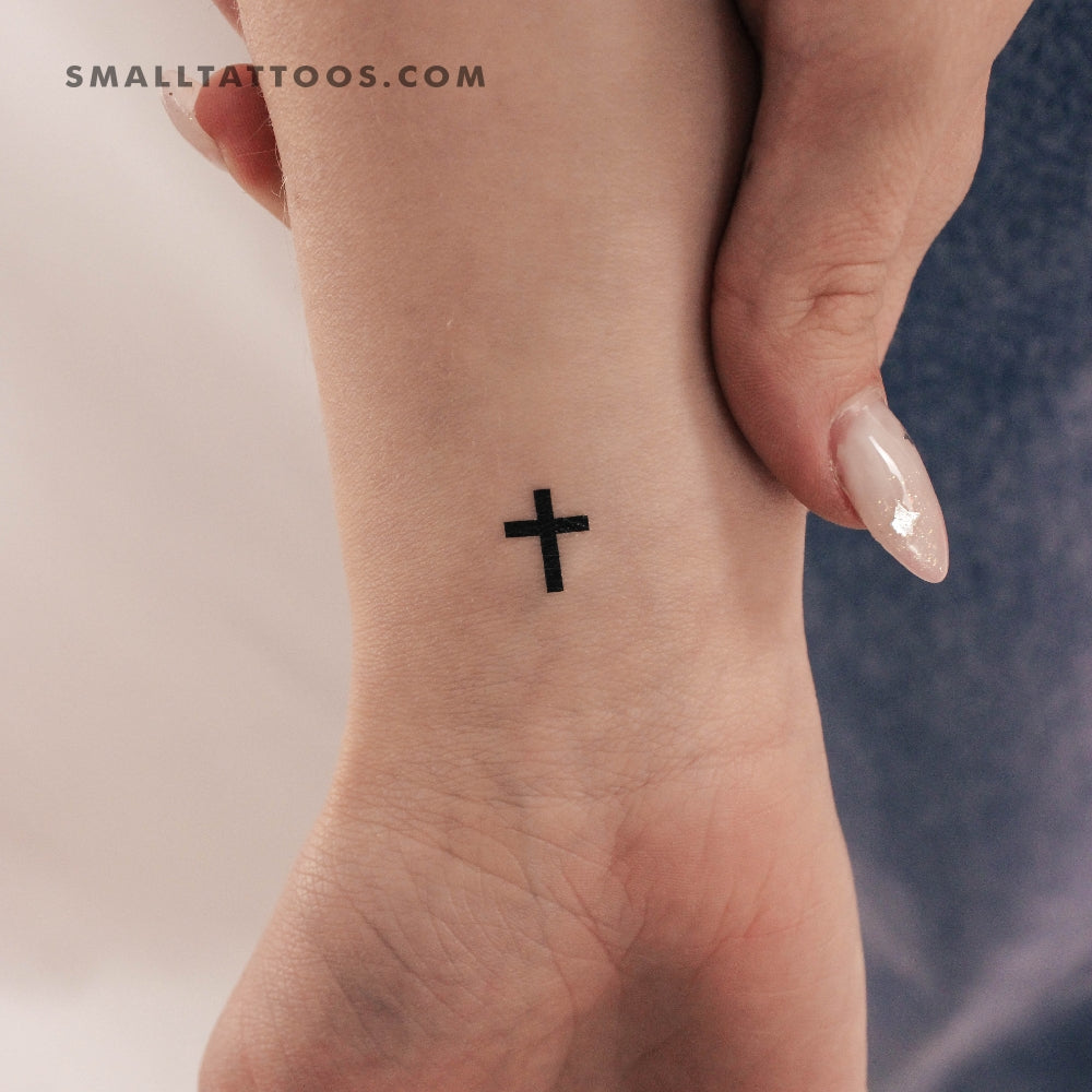 meaningful small cross face tattoo significance