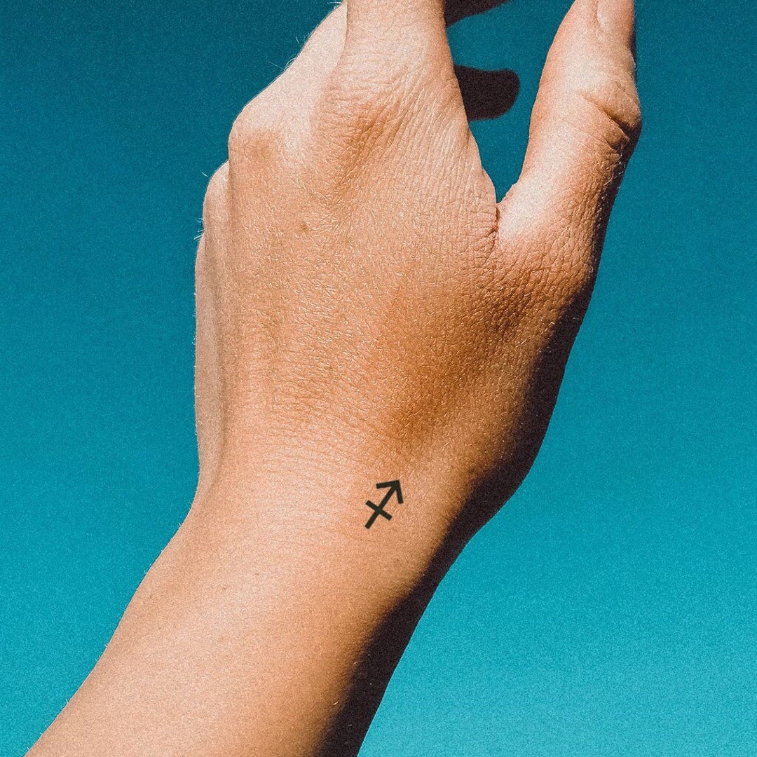 minimalist Sagittarius tattoo for girls