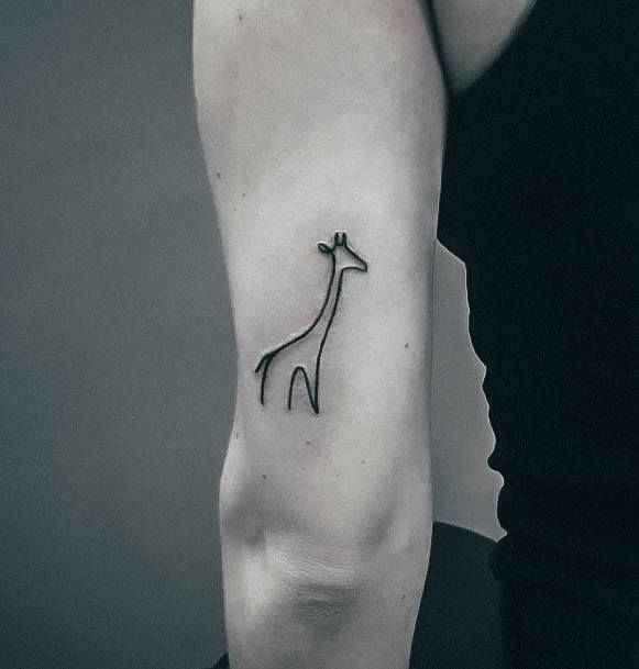 minimalist small giraffe tattoo