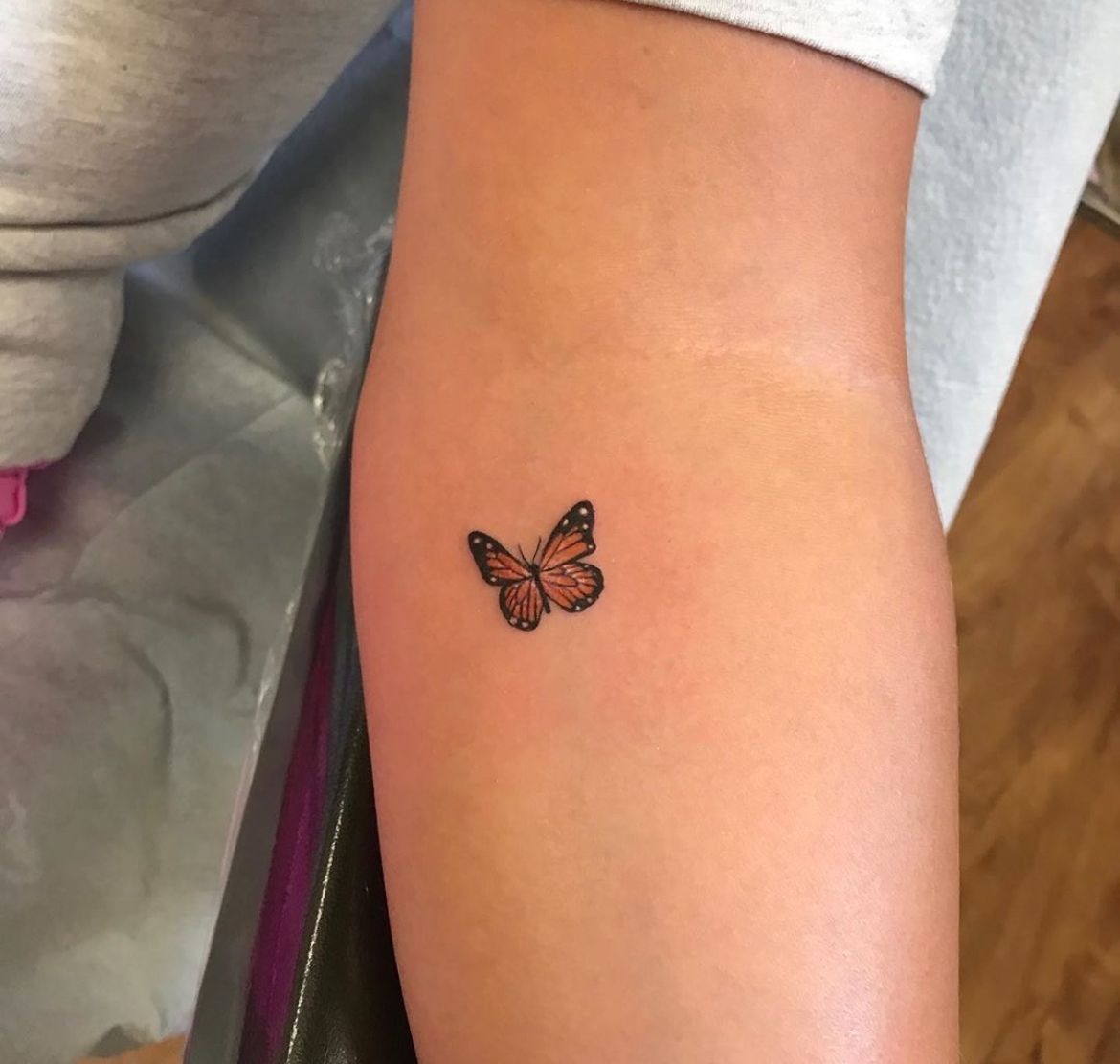 minimalist small monarch butterfly tattoo