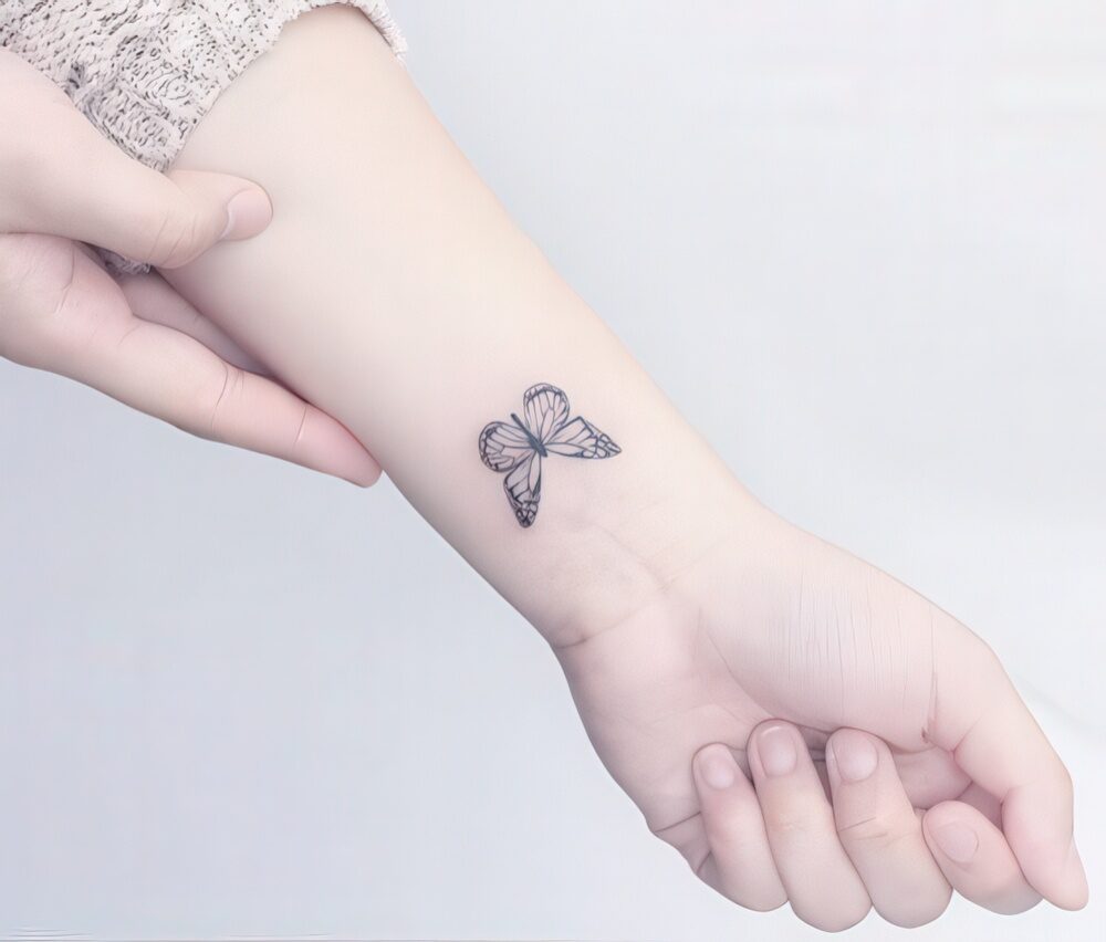 small butterfly hand tattoo 0068