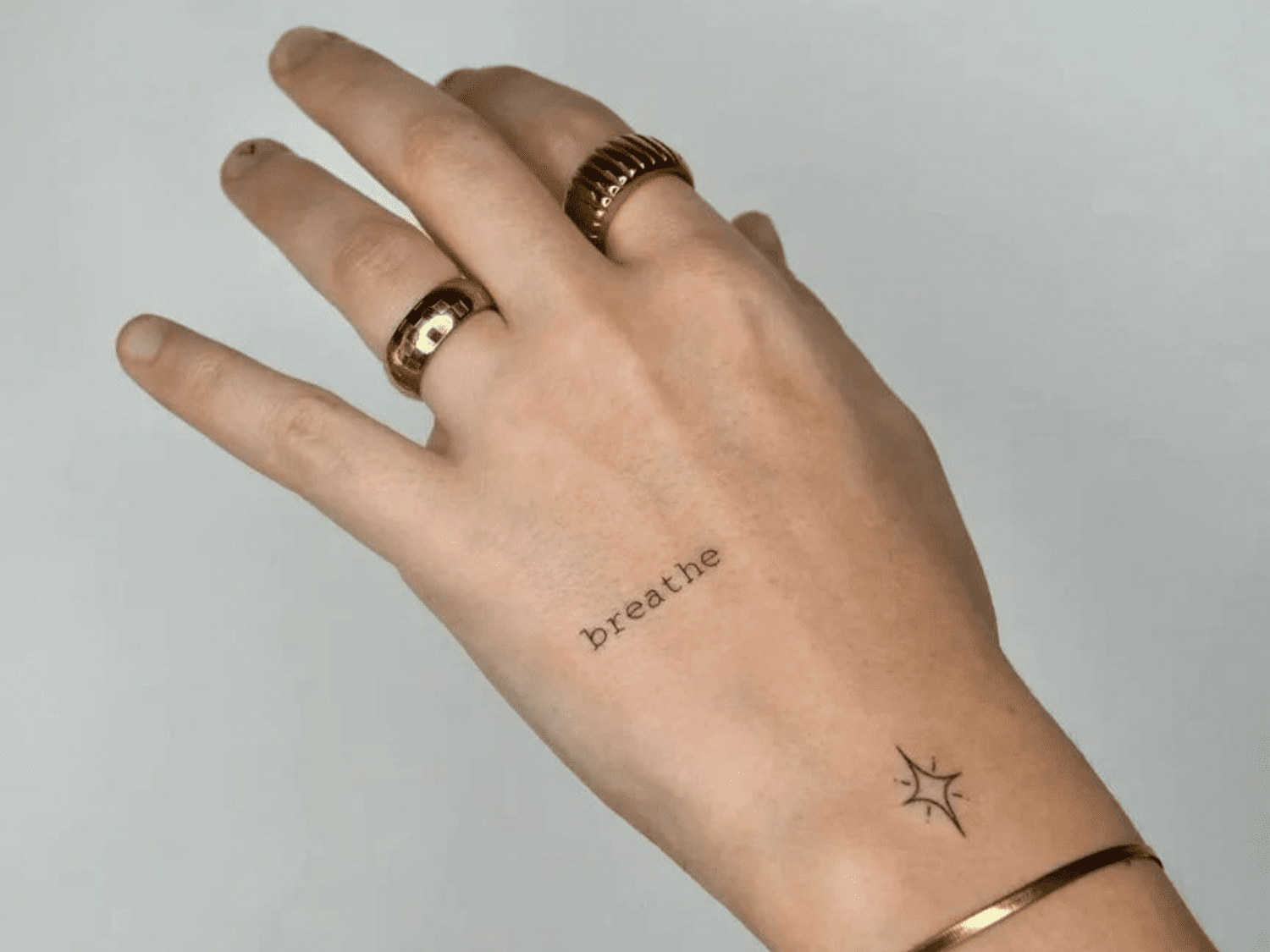 small hand tattoo meanings for men