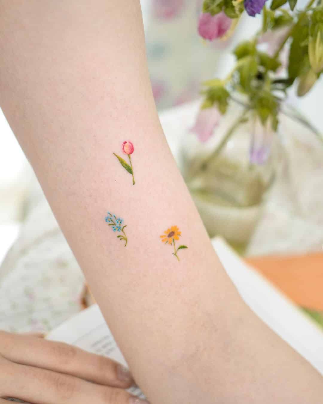 Small tulip tattoo on wrist