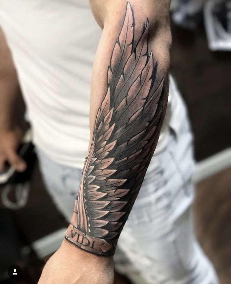 small wing tattoo on forearm for women