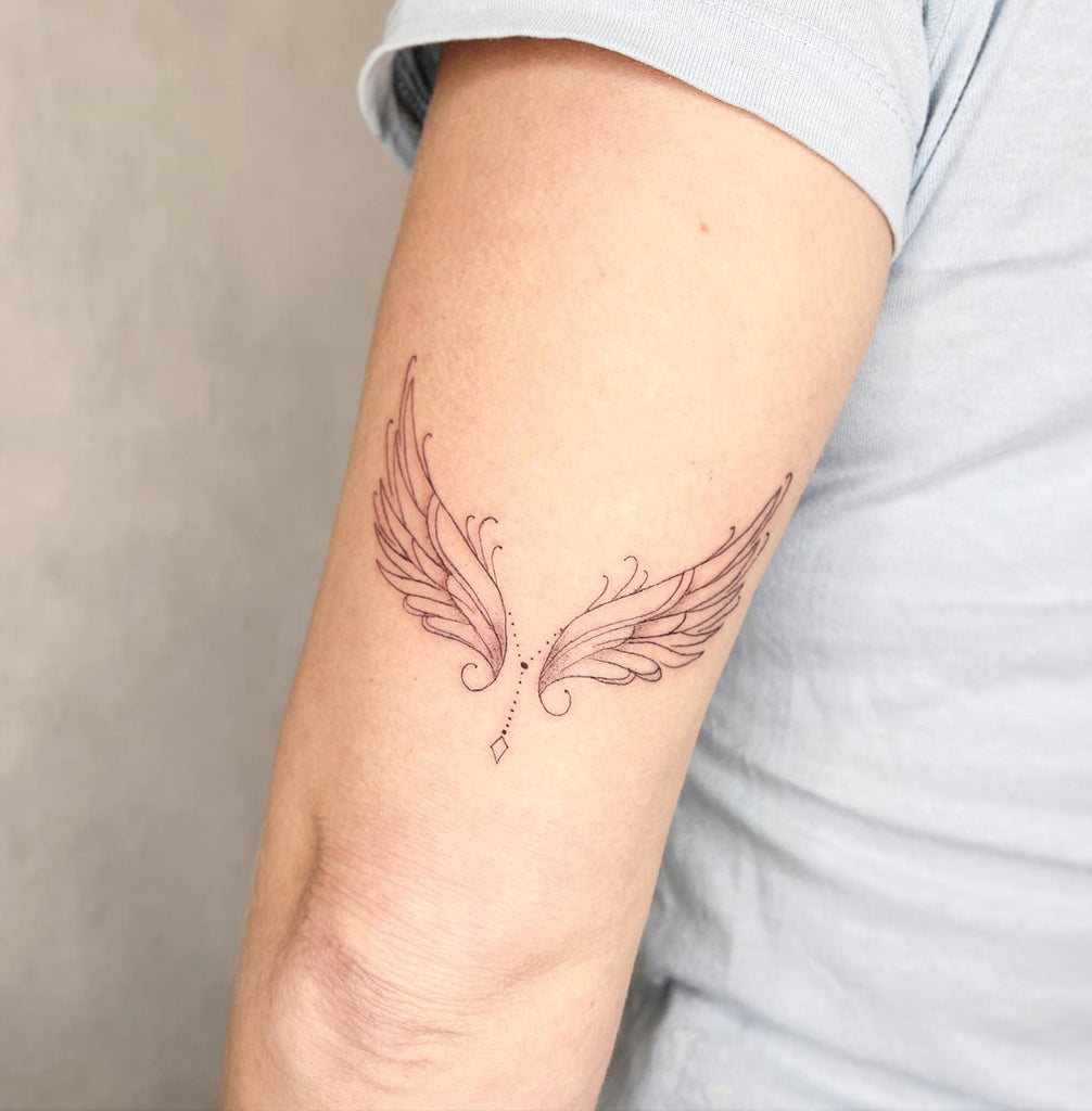 small wing tattoo on forearm 0020