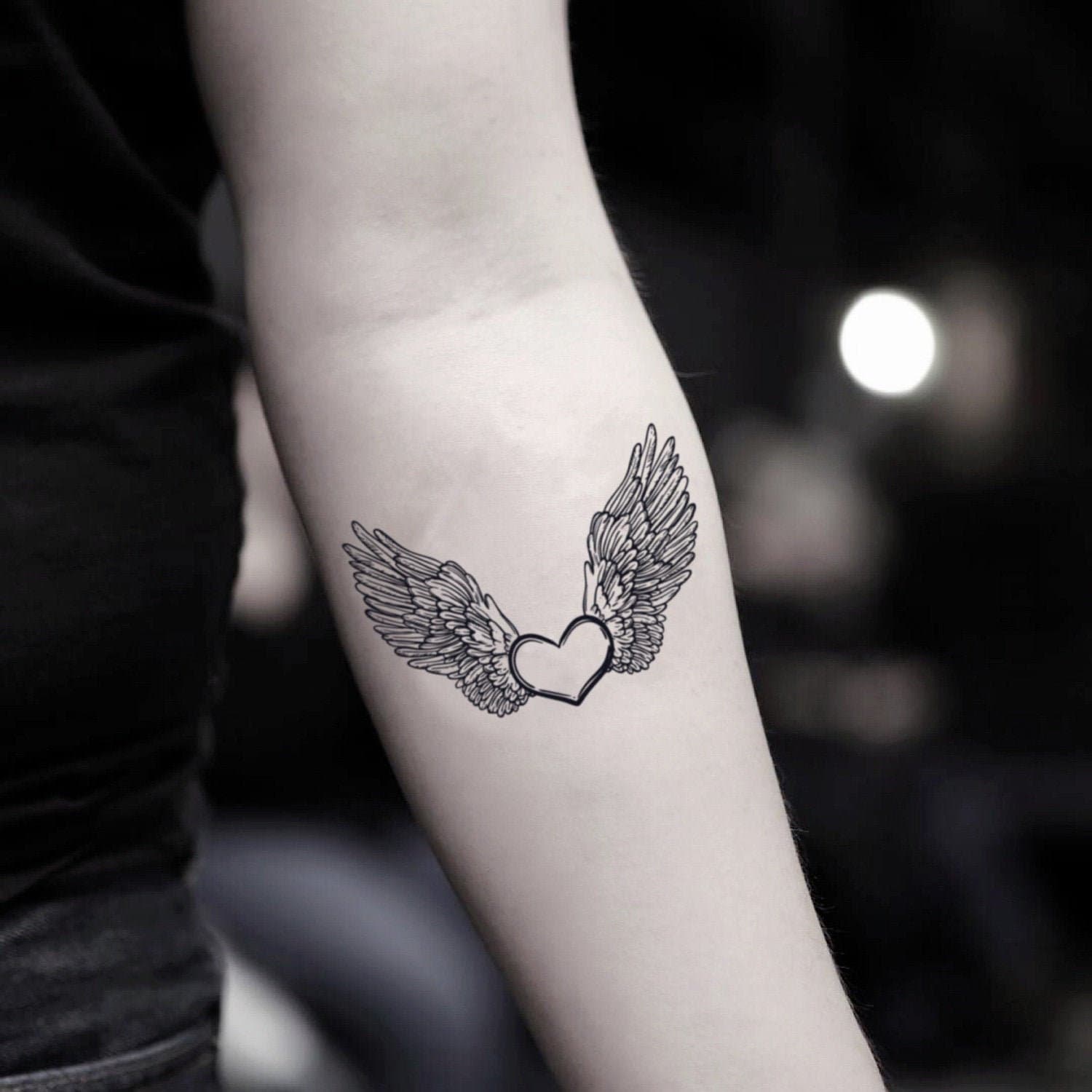 small wing tattoo on forearm 0038