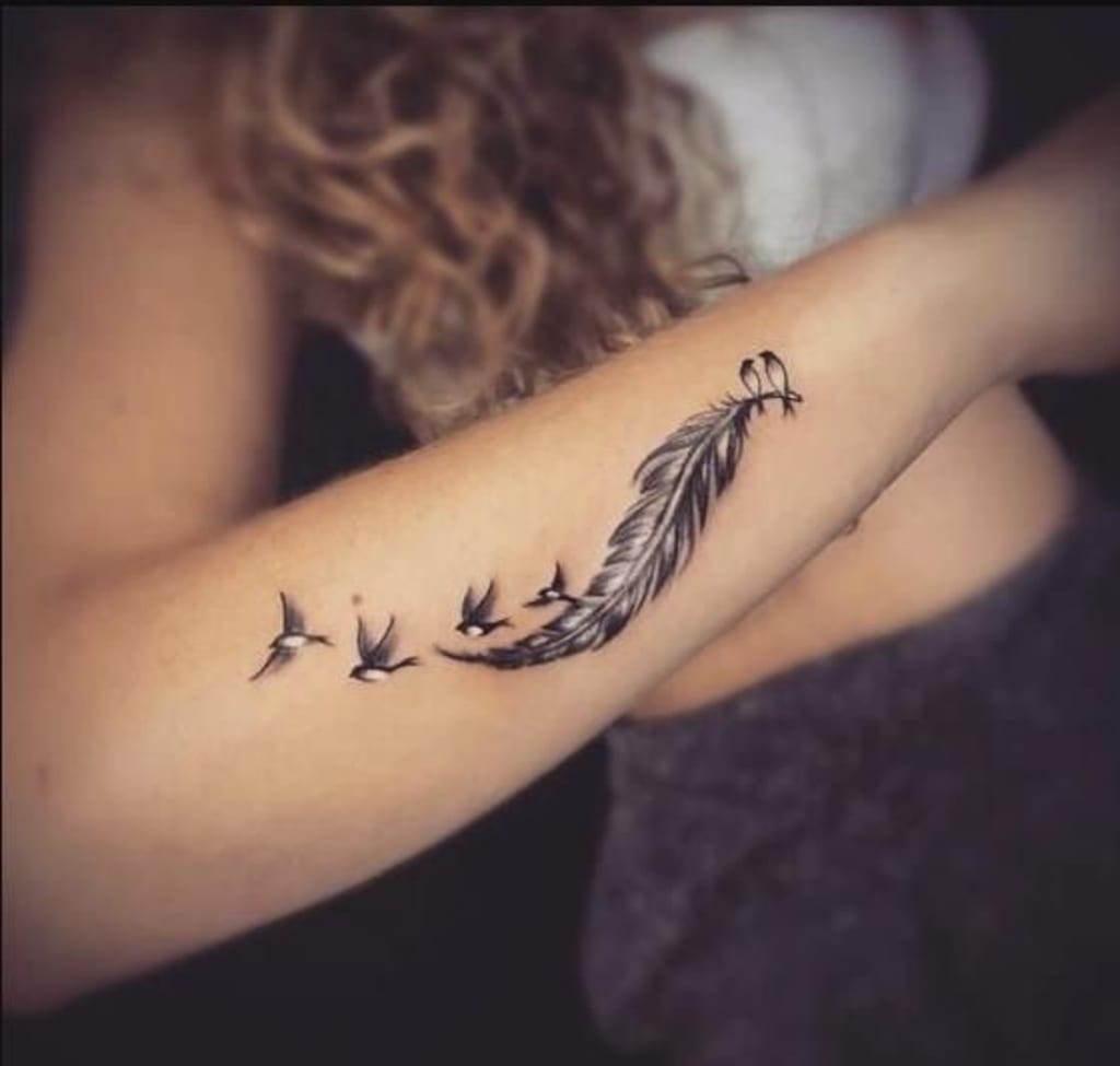 small wing tattoo on forearm 0041