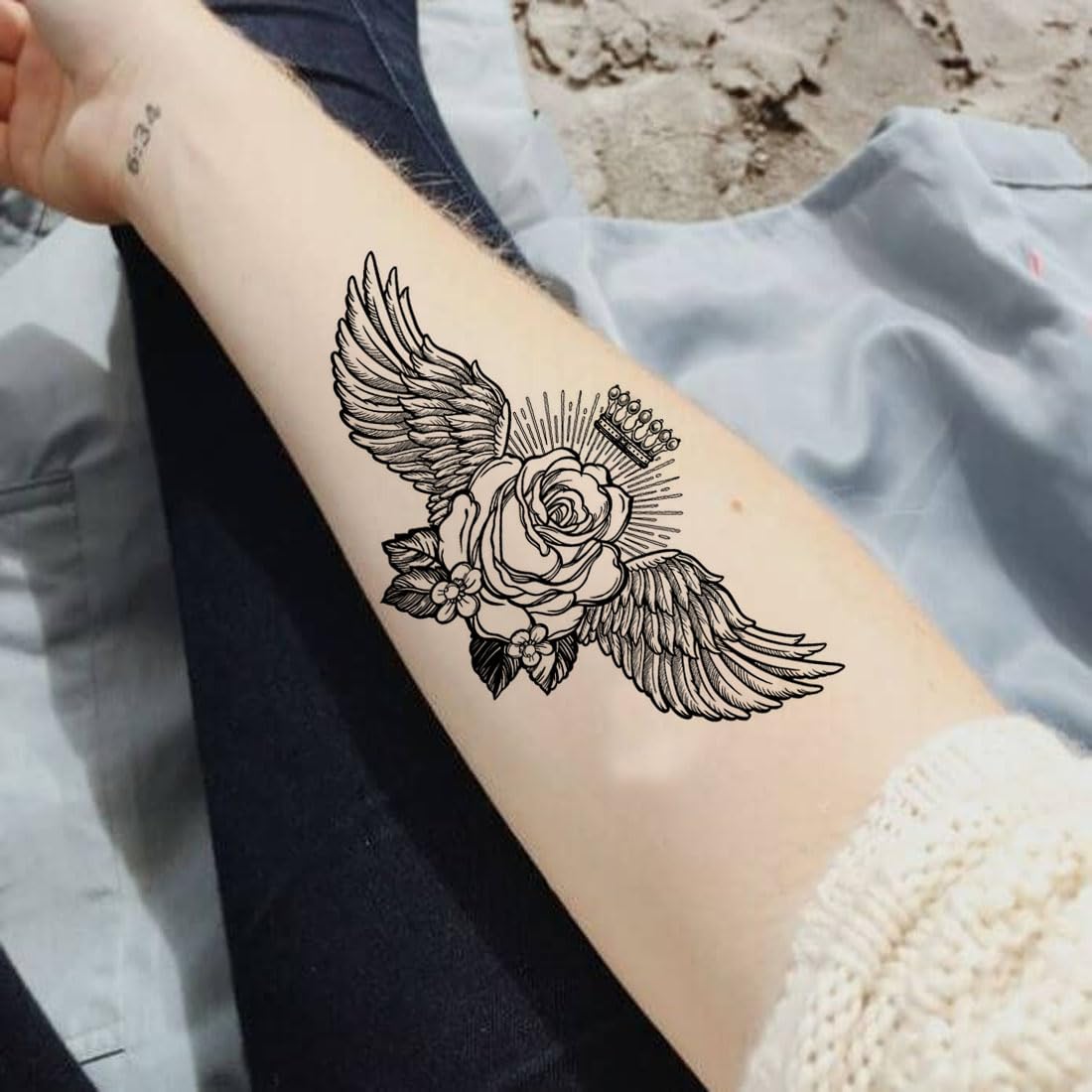 small wing tattoo on forearm 0046