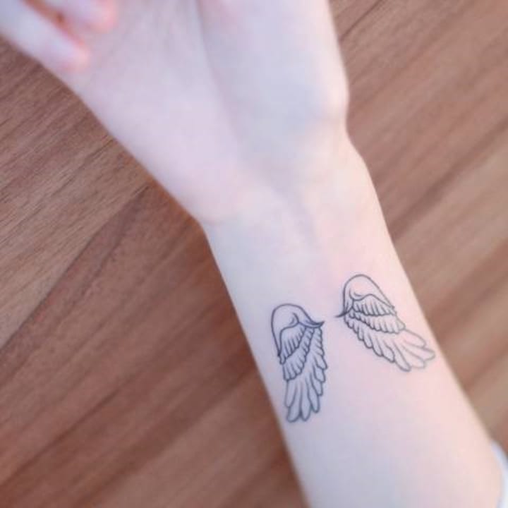 small wing tattoo on forearm 0049