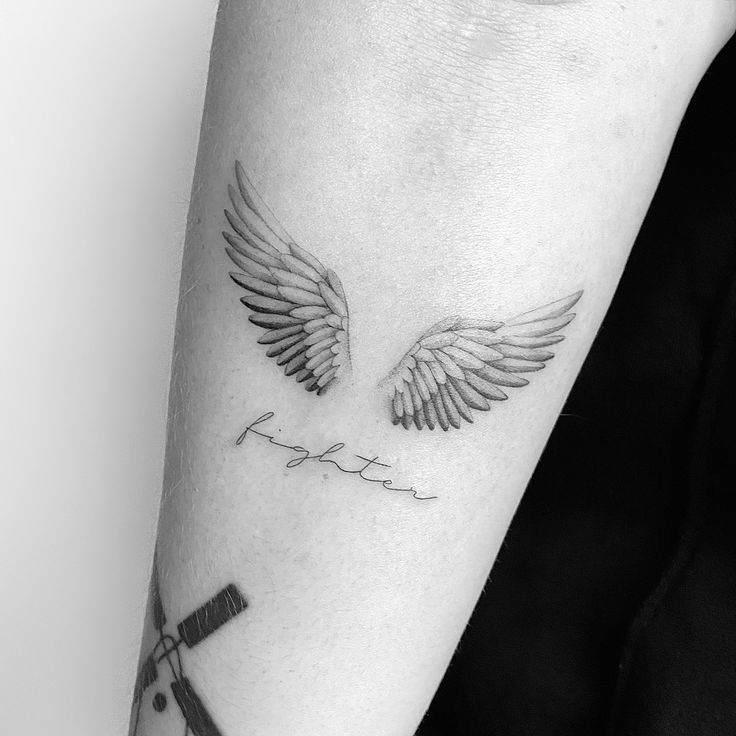 small wing tattoo on forearm 0054