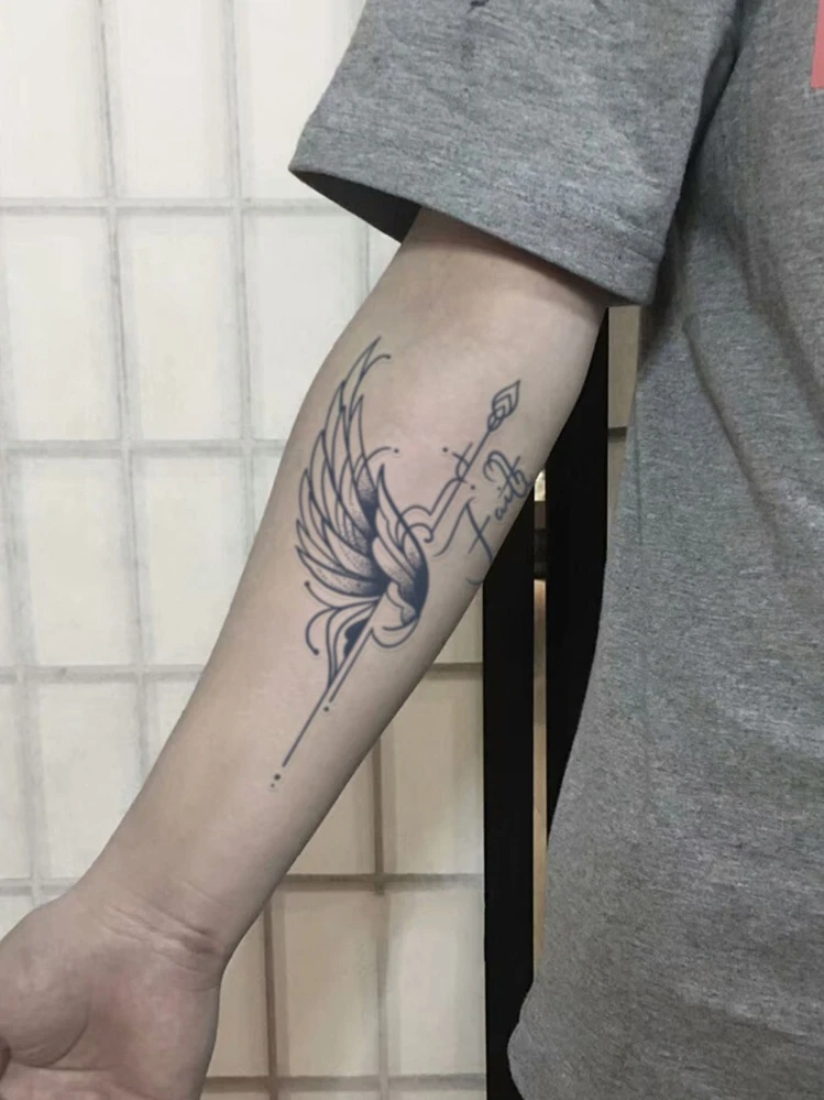 small wing tattoo on forearm 0056