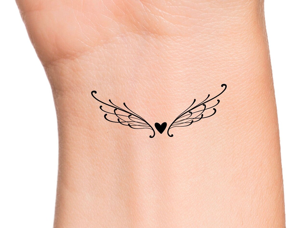 small wing tattoo on forearm 0061