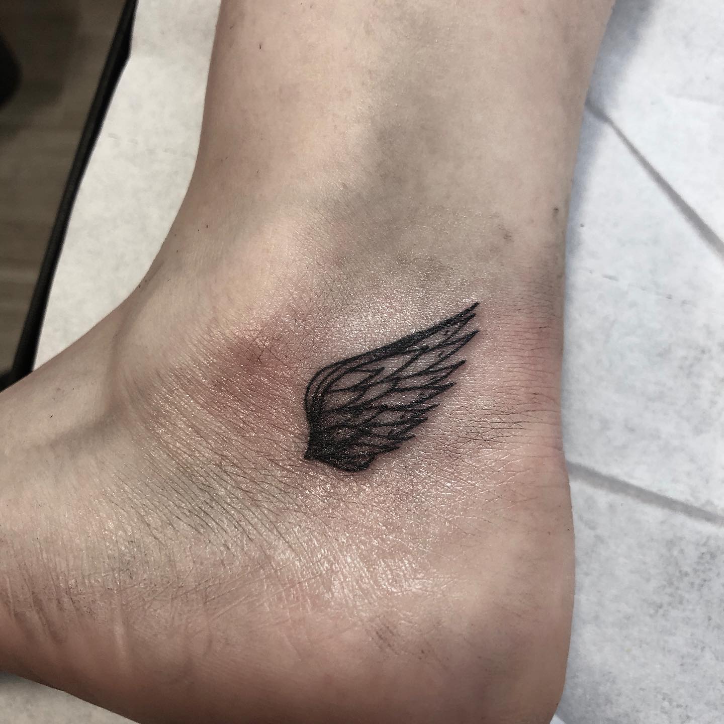 small wing tattoo on forearm 0070