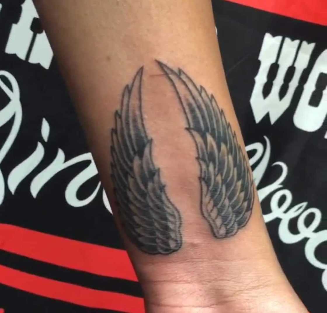 small wing tattoo on forearm 0073