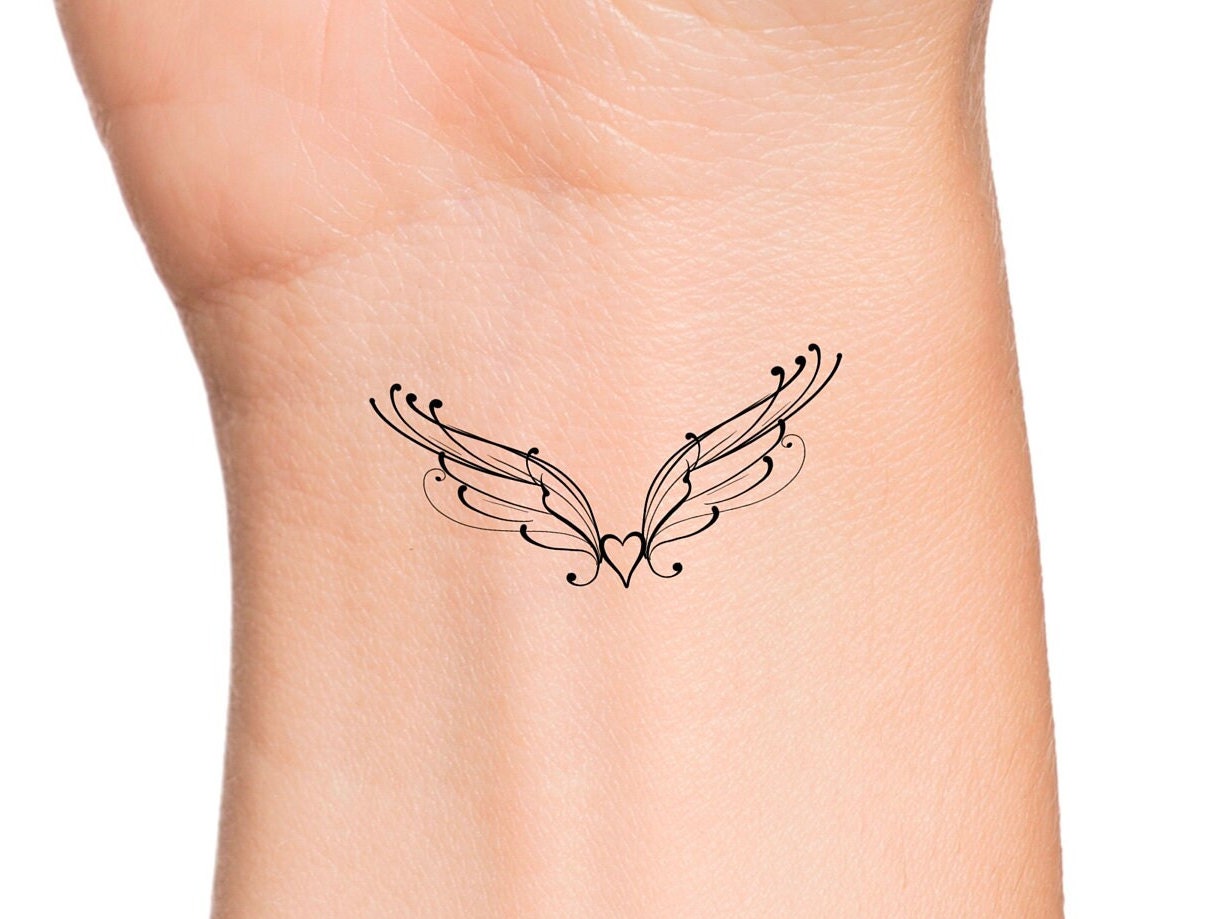 small wing tattoo on forearm 0074