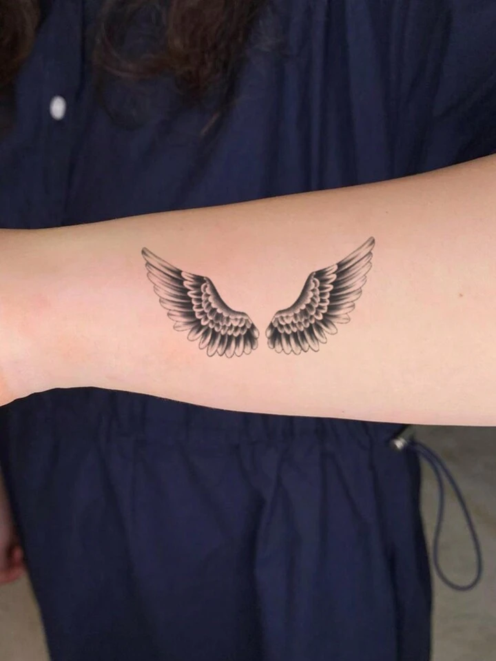 small wing tattoo on forearm 0079