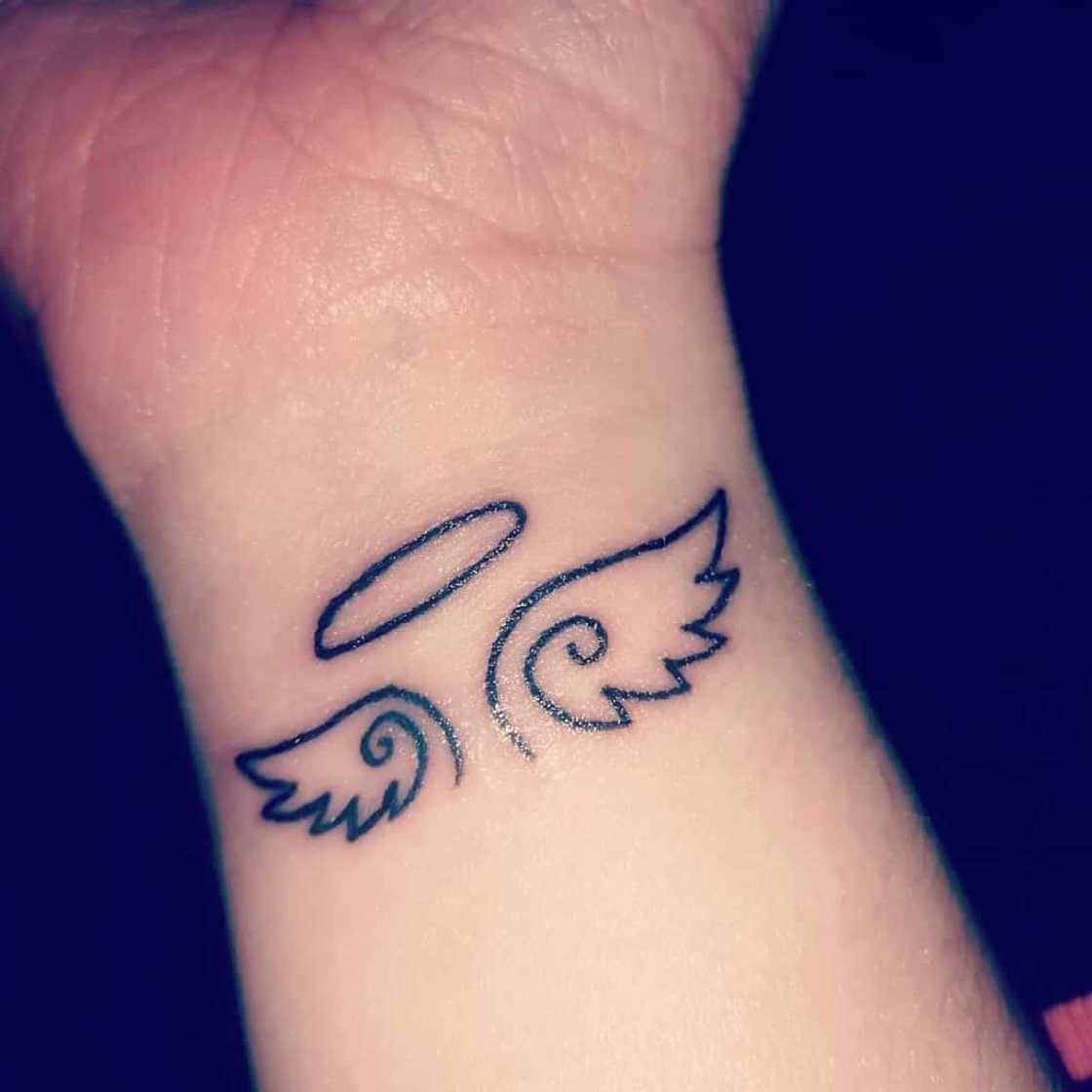 small wing tattoo on forearm 0087