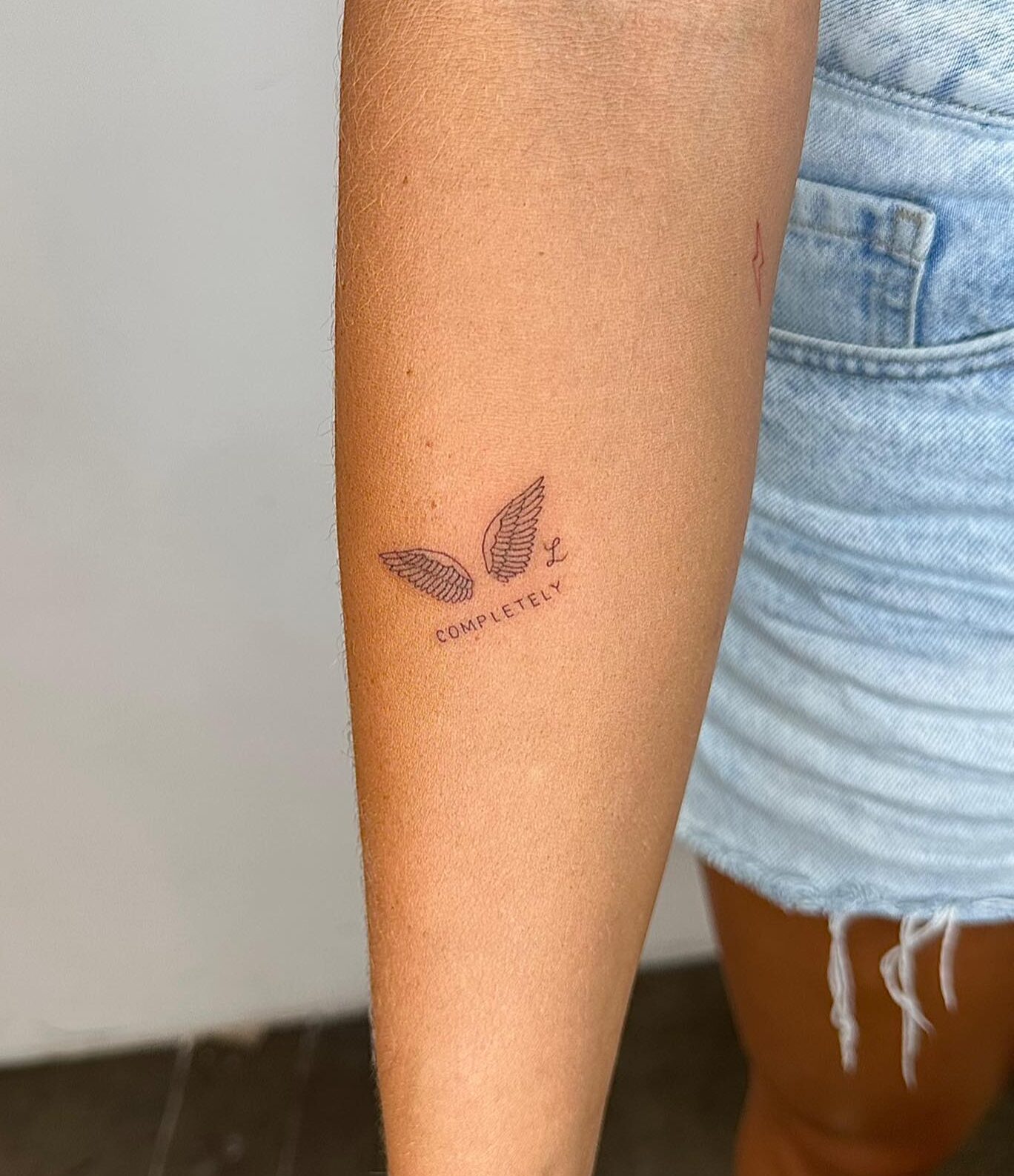 small wing tattoo on forearm 0099