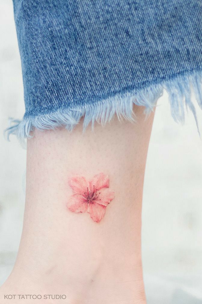 Mini small cherry blossom tattoo representing beauty and transience in life