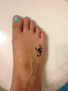 Small scorpion tattoo adorned with intricate details and elegance in design